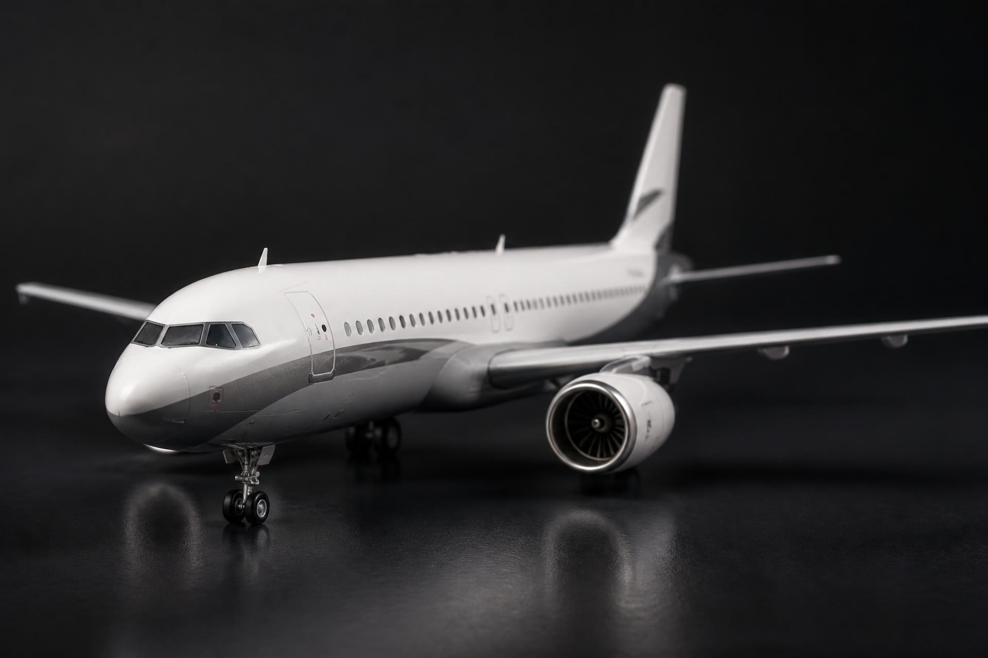 Premium scale model commercial airliner photographed under controlled studio lighting